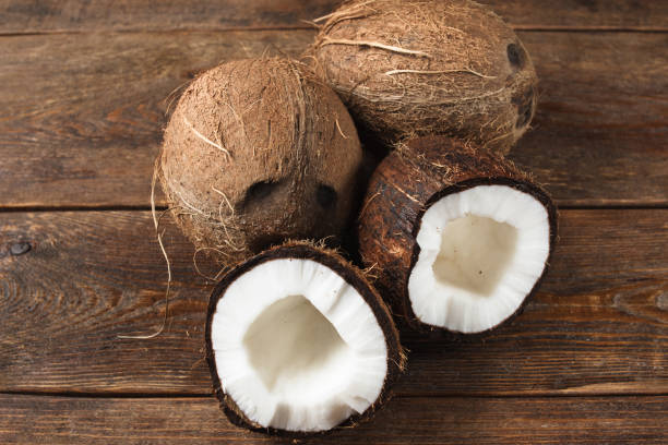istock Close up of coconuts on wooden background 825159646