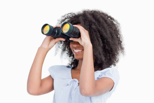 istock Young woman looking on the side through binoculars 825159928