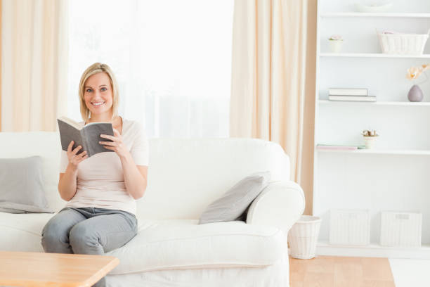 istock Blondhaired woman with a book 825160058