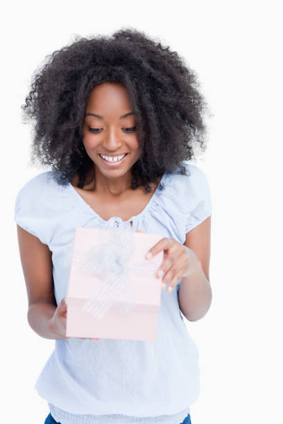istock Happy young woman opening her birthday gift 825160108