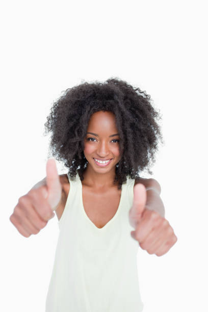 istock Relaxed young woman putting her thumbs up in satisfaction 825160380