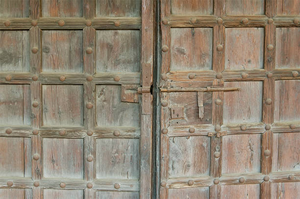 istock Old wooden door with metal elements 825160664
