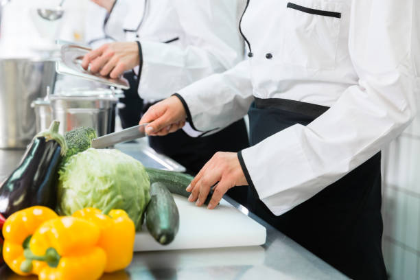 istock Chefs preparing meals in commercial kitchen 825164088