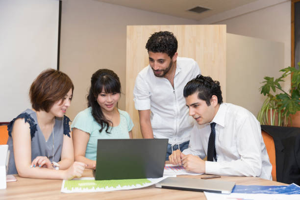 istock Employees gathered around a laptop 825168212
