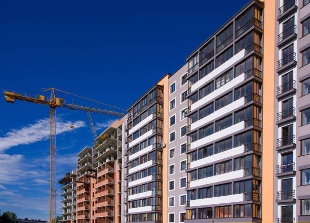 istock apartment building on blue sky background 825170738