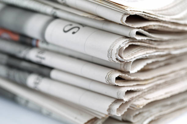 Newspapers folded and stacked concept stock photo