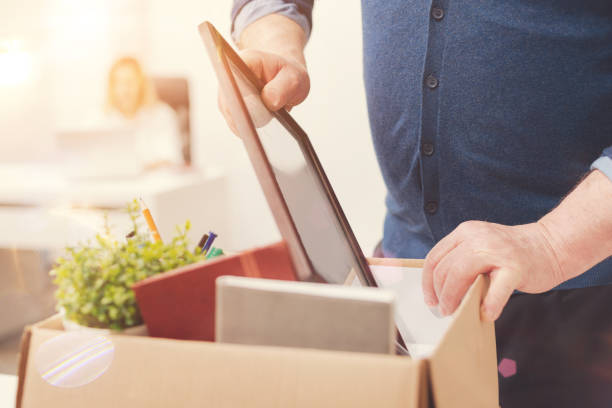 Attentive precise man packing his belongings Sad ritual. Qualified aged stout gentleman taking all his stuff with him as he leaving the office while being fired belongings stock pictures, royalty-free photos & images