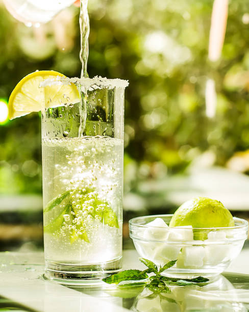 istock Fresh cool lemonade with mint and lime. Splash and bubbles on glass 825176850