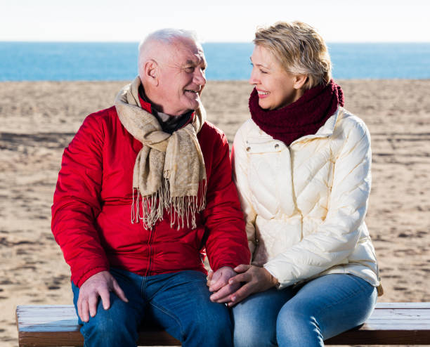 istock Mature couple sitting by sea 825179930