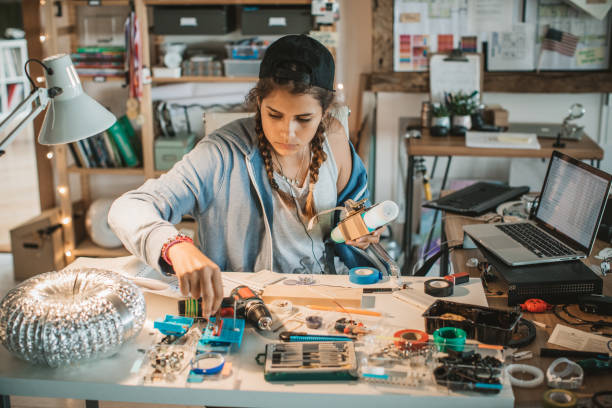 istock Teenage girl experimenting with electronics 825180542