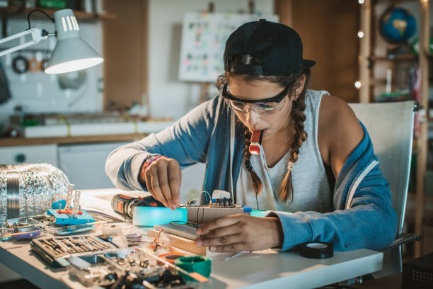 She has a passion for science Teenage girl working on some engineering project at home. stem research stock pictures, royalty-free photos & images