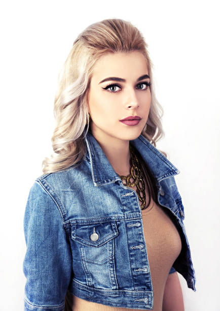Attractive woman in denim jacket studio portrait