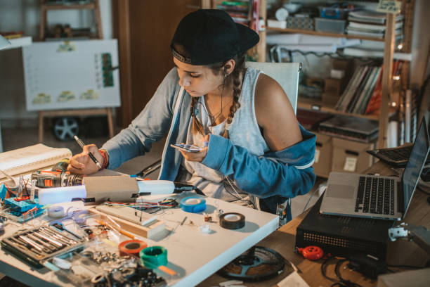 istock Teenage girl experimenting with electronics 825181432