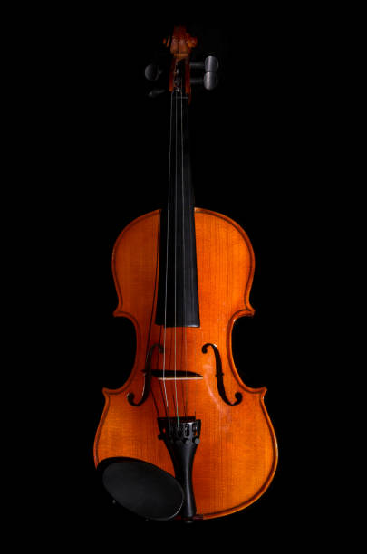 istock Violin orchestra musical instruments on black background 825186916