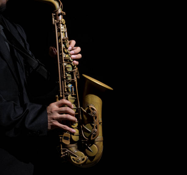 istock Closeup saxophone in player action on a dark background 825186932