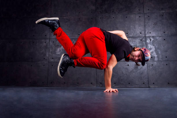 Dancer in motion Guy break dancing isolated on black background. Urban style handspring stock pictures, royalty-free photos & images