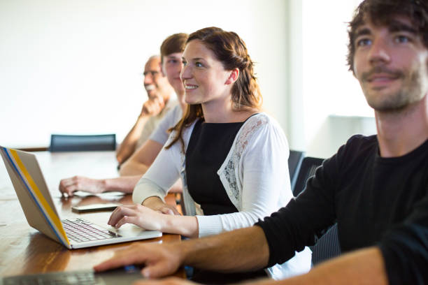 istock Young woman in meeting with colleagues 825190466