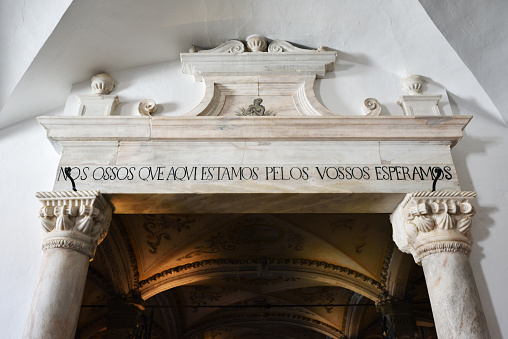 Evora, Portugal - June 12, 2017: Entrance in Chapel of Bones, is one of the best known monuments in Evora. The message above entrance means: We bones that here are, for yours await