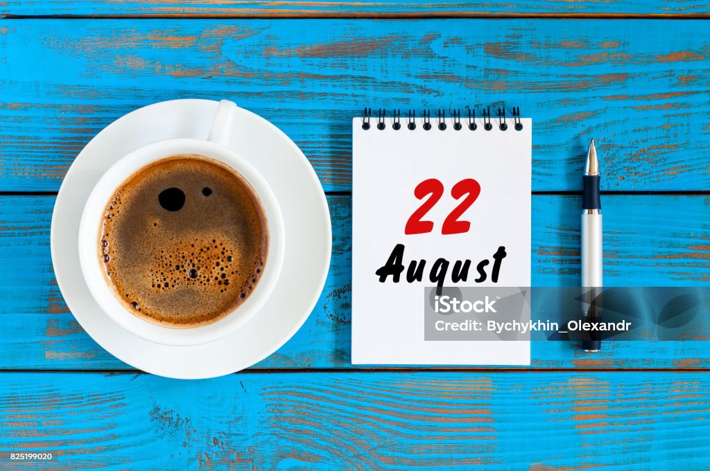 August 22nd. Day 22 of month, daily calendar on blue background with morning coffee cup. Summer time. Unique top view August 22nd. Day 22 of month, daily calendar on blue background with morning coffee cup. Summer time. Unique top view. Abstract Stock Photo