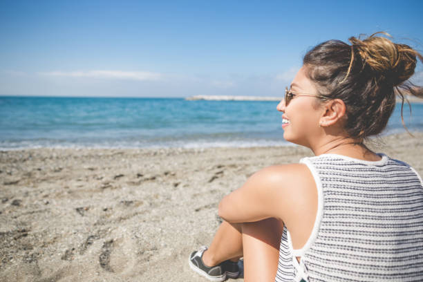 istock Young beautiful woman relaxing on beach 825203576