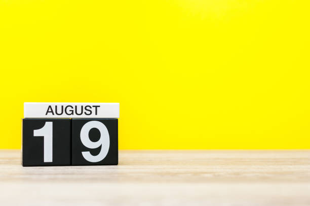 istock August 19th. Image of august 19, calendar on yellow background with empty space for text. Summer time 825208288