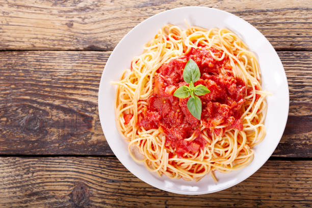 istock plate of pasta with tomato sauce and green basil 825211416