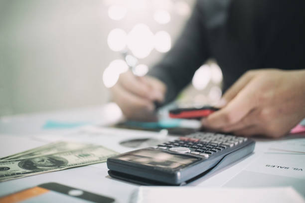 istock calculate on desk with Business man doing finance. 825216204