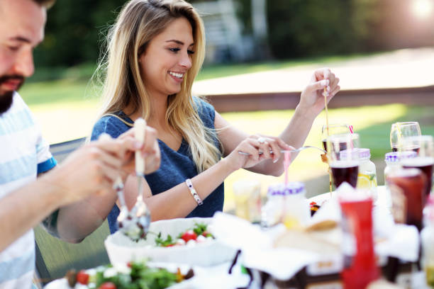 istock Friends having barbecue party in backyard 825216252