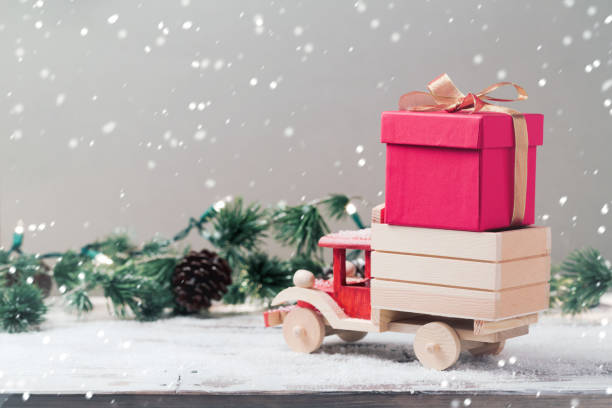 istock Christmas gift box on toy truck 825216480