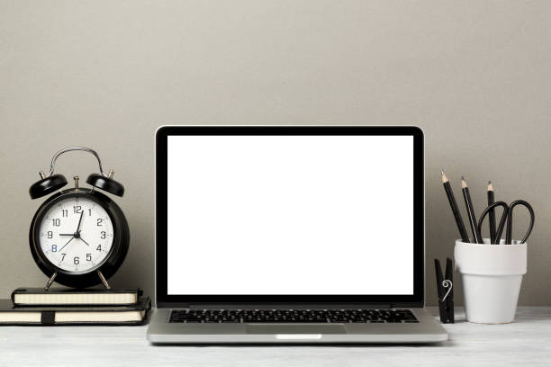 istock Laptop computer mock up with pencil and alarm clock. Modern stylish interior background for social media and marketing. 825216582