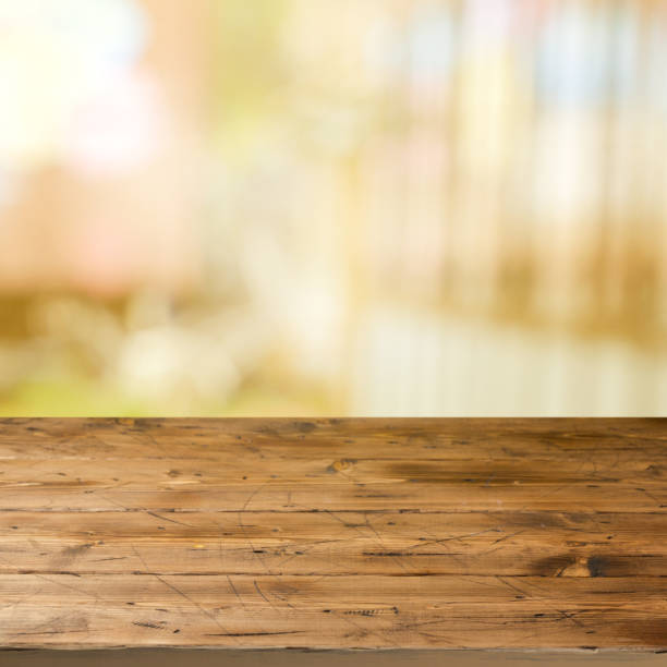 istock Empty wooden table over outdoor blurred bokeh background 825216604