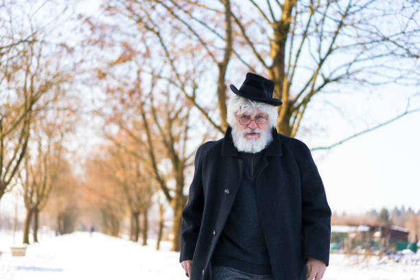 istock Modern senior with old hat on his head and glasses 825216846