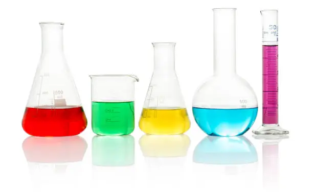 laboratory glassware filled with colorful liquid on white background