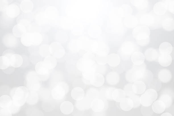 istock White bokeh lights on gray background 825219684
