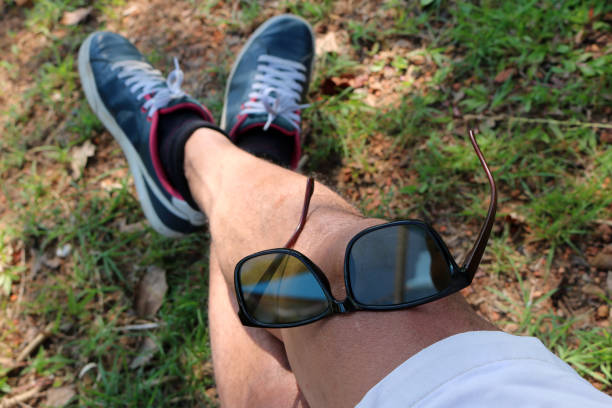istock Sunglasses on the leg of a man 825219810