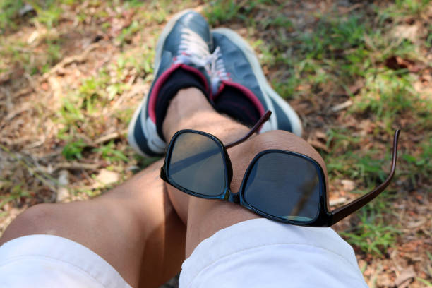 istock Sunglasses on the leg of a man 825219938