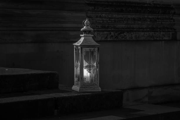 The old lantern with candle on stone step of stairs.