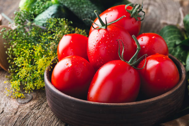 istock Ripe organic cucumbers and tomatoes, preparation for pickling vegetables 825222872