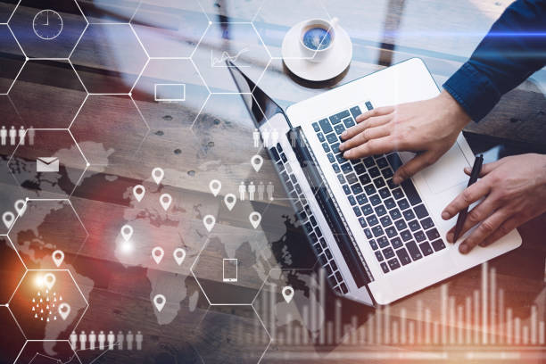 istock Concept of digital screen,virtual connection icon,diagram,graph interfaces.Man working with laptop at office at wooden table.Reflections on glass surface.Flares effect.Horizontal. 825223420