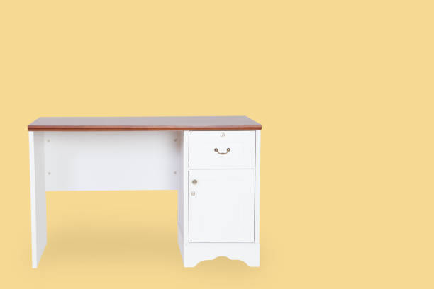 istock Empty desk isolated on yellow background with space for copy. 825223916