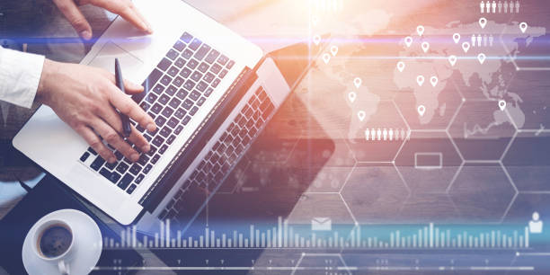 istock Concept of digital screen,virtual connection icon,diagram,graph interfaces.Businessman working with laptop at office.Modern notebook,cup of black coffee on wooden table.Sunlight effect glass surface. 825223954