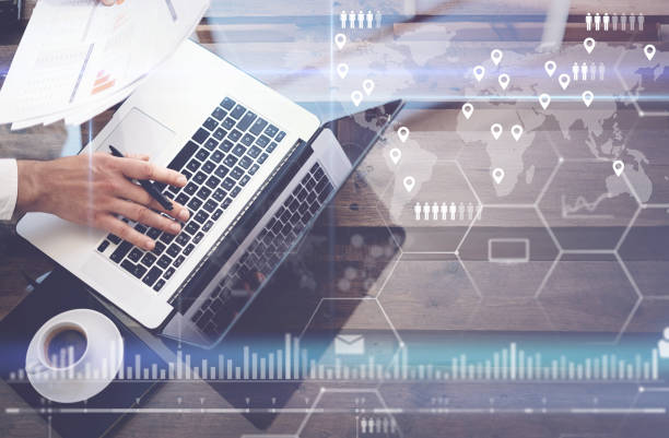 istock Concept of digital screen,virtual connection icon,diagram,graph interfaces.Man working with laptop at office.Modern mobile computer,cup of black coffee on wooden table.Reflections on glass surface. 825224018
