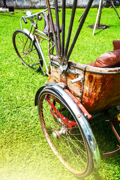 istock Three-wheeled classic tricycle show in park green grass 825227068