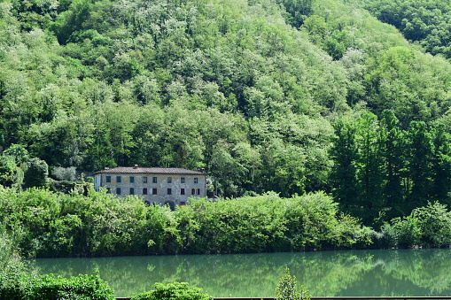 Beautiful old villa sitting on lush northern Tuscan river.