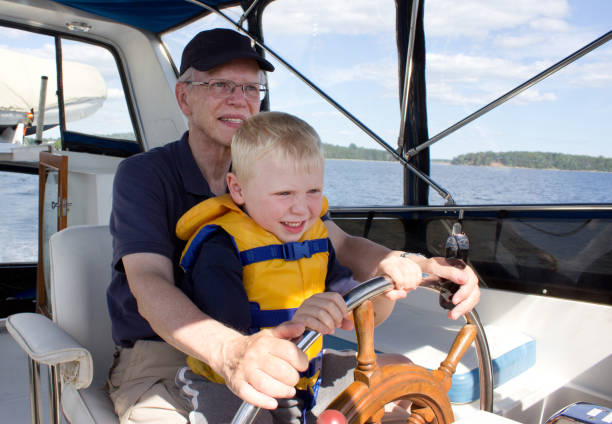 istock little boy with grandather on a boat 825231272