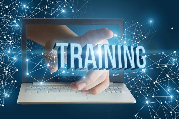 istock Hand from laptop clicks on the word training. 825232002