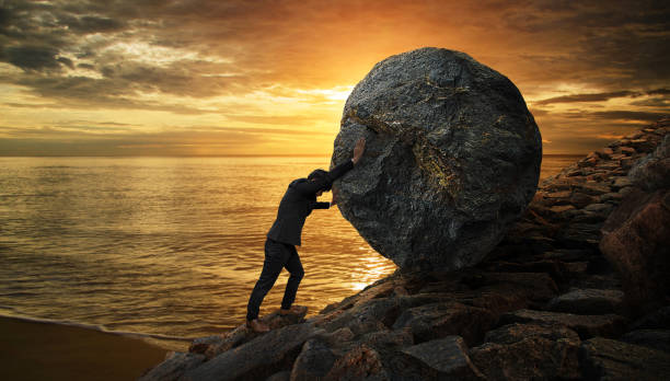 istock Business man pushing large stone up to hill , Business heavy tasks and problems concept. 825235740