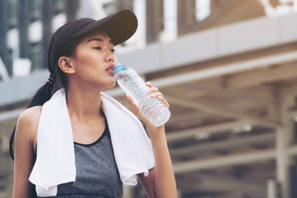 istock Sport woman with drinking water bottle 825235892