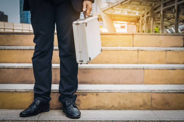 istock Business man holding metallic briefcase 825236012