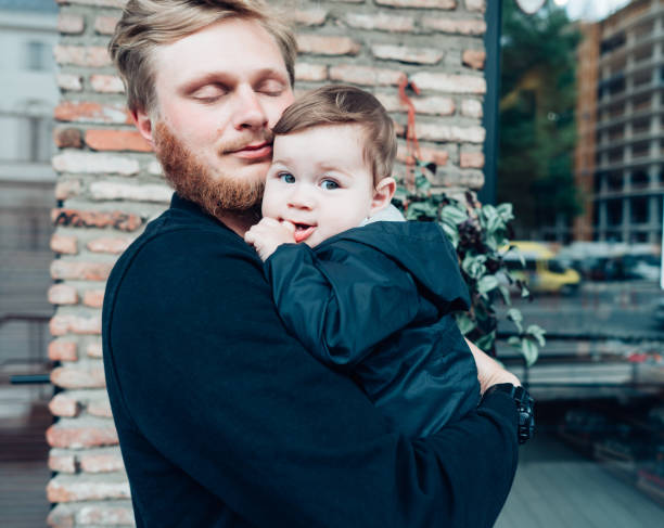 istock Dad with a small son in his arms 825243688